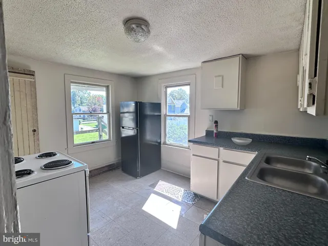 a kitchen that has a sink and a stove in it