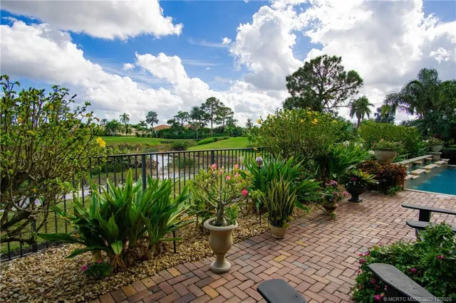 a view of a porch with chairs and potted plants