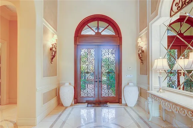 a bedroom with a bed and a large window with outer view