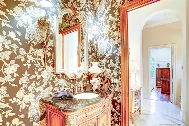 a spacious bathroom with a granite countertop sink and a mirror