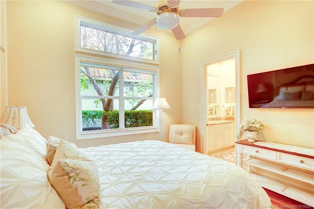 a bedroom with a large bed and a large window