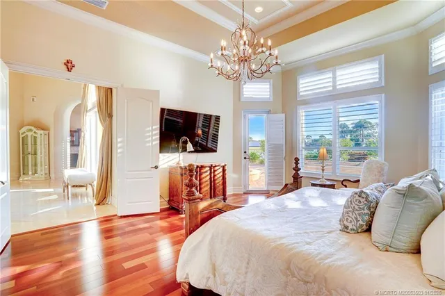 a view of a balcony with wooden floor next to a yard