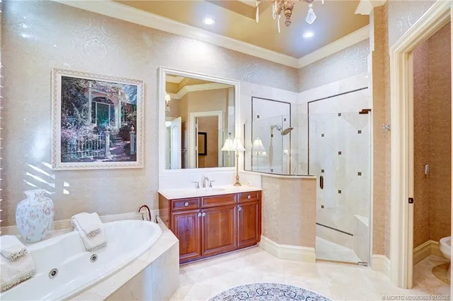 a view of a white house with a floor to ceiling window and potted plants