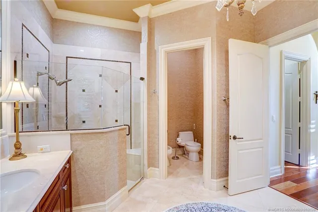 a view of a garden with plants and brick wall