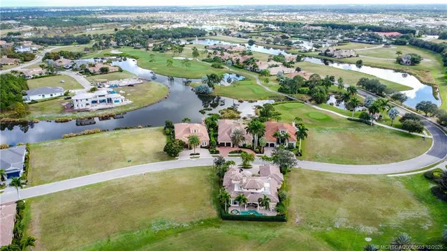 an aerial view of a house with a swimming pool yard and outdoor seating