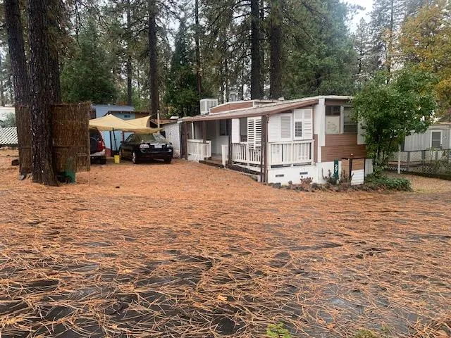a view of a house with a yard covered with snow in the patio