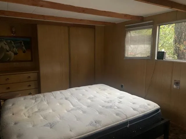 a bed sitting in a bedroom next to a window