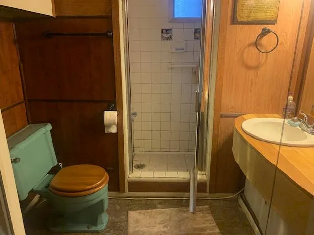 a bathroom with a toilet and a shower