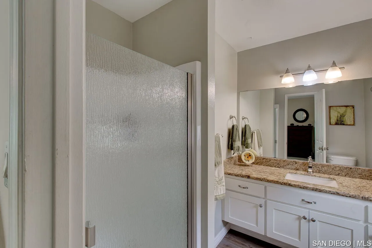 4700 Circle Lazy J Road Riverside, CA 92501 - Photo 12 of 24 a bathroom with a granite countertop sink and a mirror