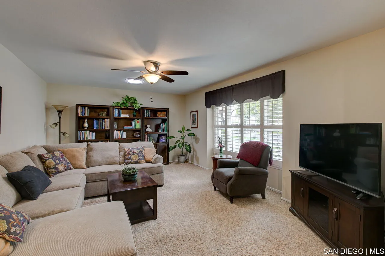 4700 Circle Lazy J Road Riverside, CA 92501 - Photo 15 of 24 a living room with furniture a flat screen tv and a large window