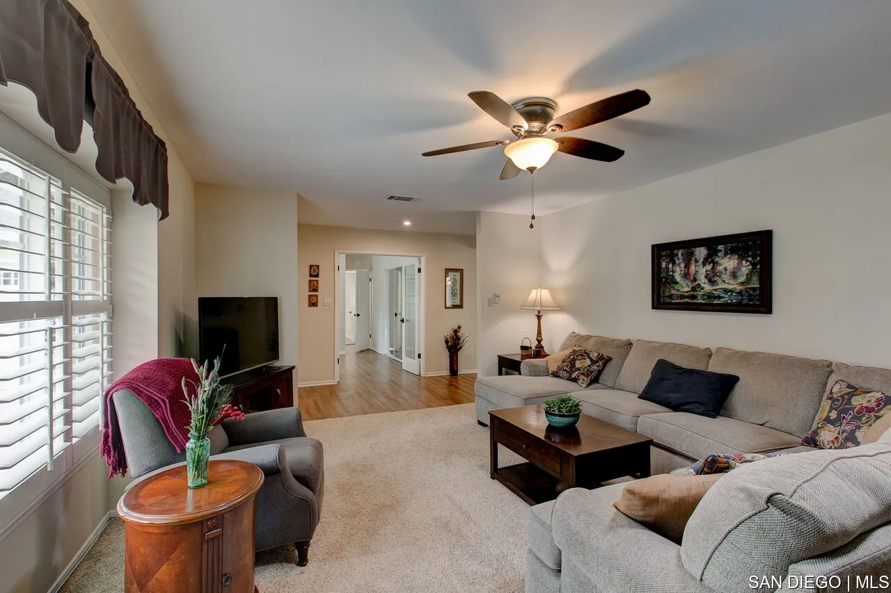 4700 Circle Lazy J Road Riverside, CA 92501 - Photo 16 of 24 a living room with furniture a ceiling fan a fireplace and a window