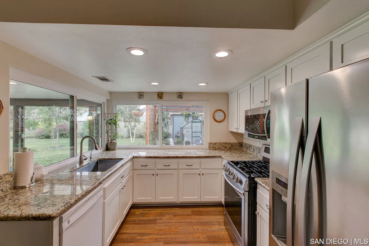 4700 Circle Lazy J Road Riverside, CA 92501 - Photo 4 of 24 a kitchen with stainless steel appliances a sink stove refrigerator and cabinets