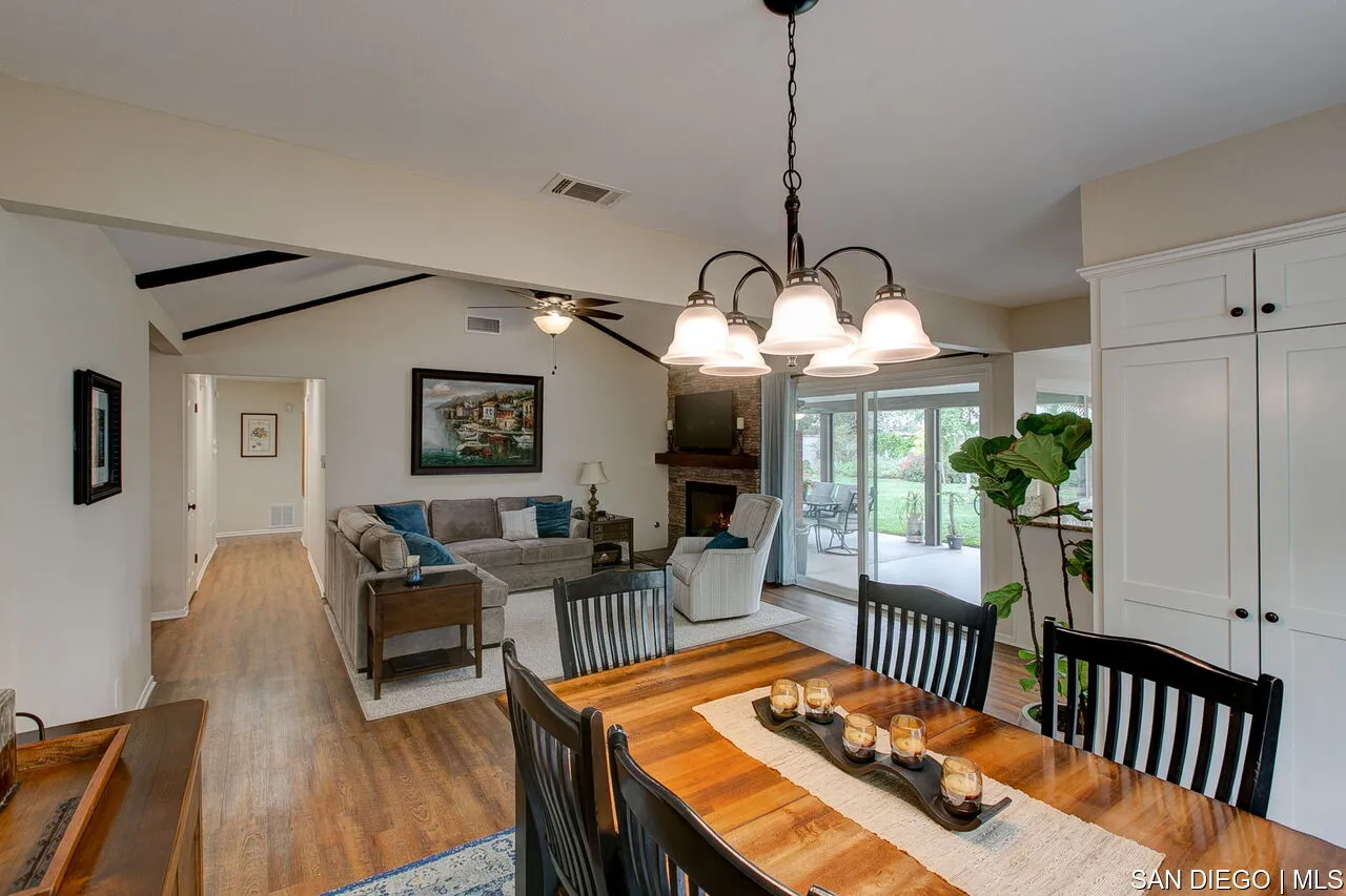 4700 Circle Lazy J Road Riverside, CA 92501 - Photo 7 of 24 a view of a dining room and livingroom with furniture wooden floor a chandelier