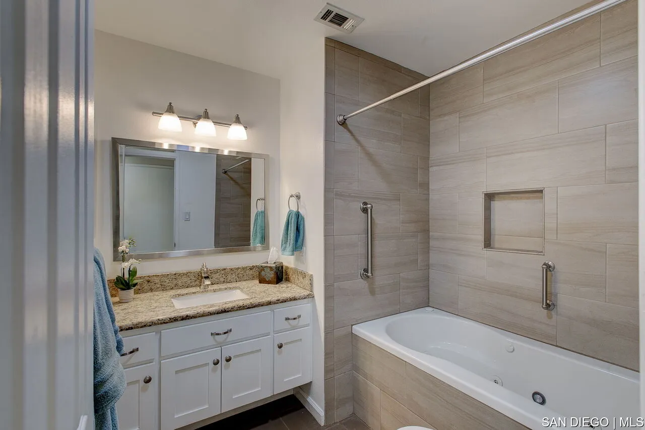 4700 Circle Lazy J Road Riverside, CA 92501 - Photo 10 of 24 a bathroom with a granite countertop sink a large mirror and a bathtub