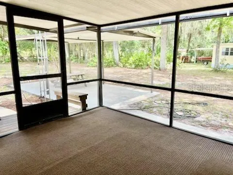 a view of a chair and table in the room