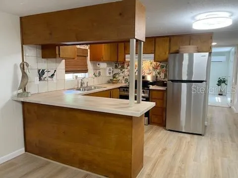 a kitchen with stainless steel appliances a refrigerator and a sink