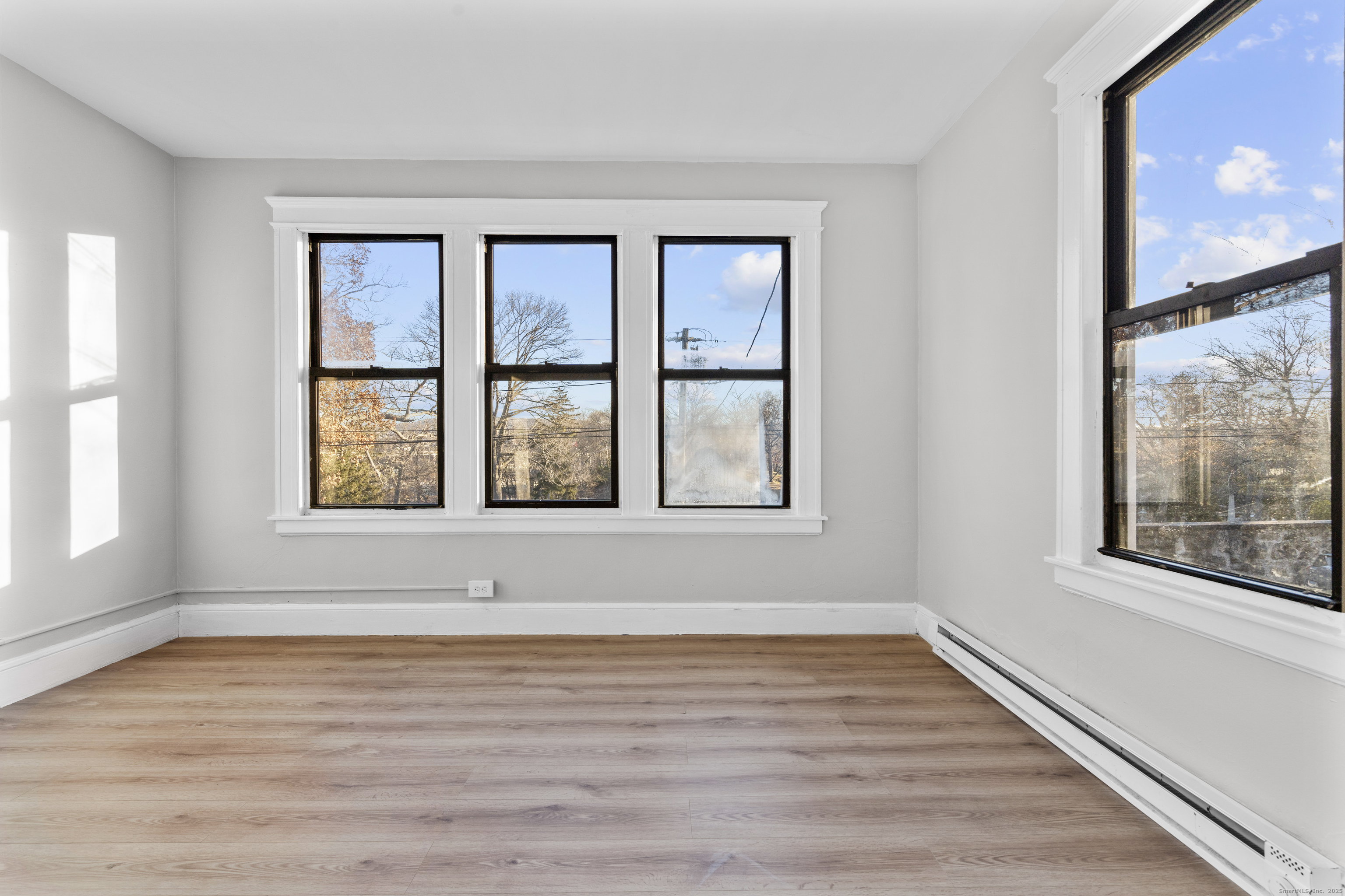 141 Draher Street Waterbury, CT 06708 - Photo 5 of 20 a view of an empty room with wooden floor and a window