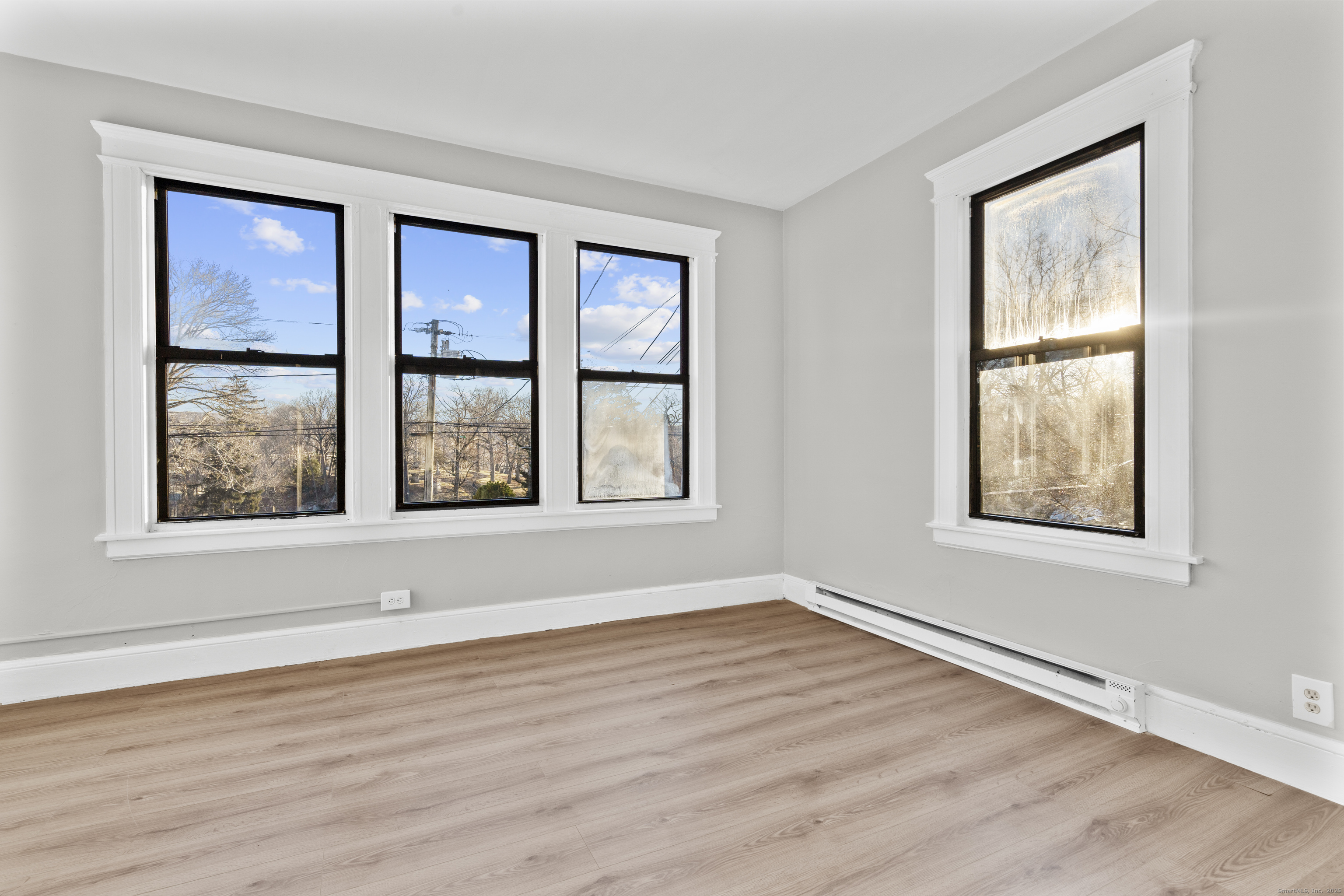 141 Draher Street Waterbury, CT 06708 - Photo 9 of 20 a view of an empty room with wooden floor and a window