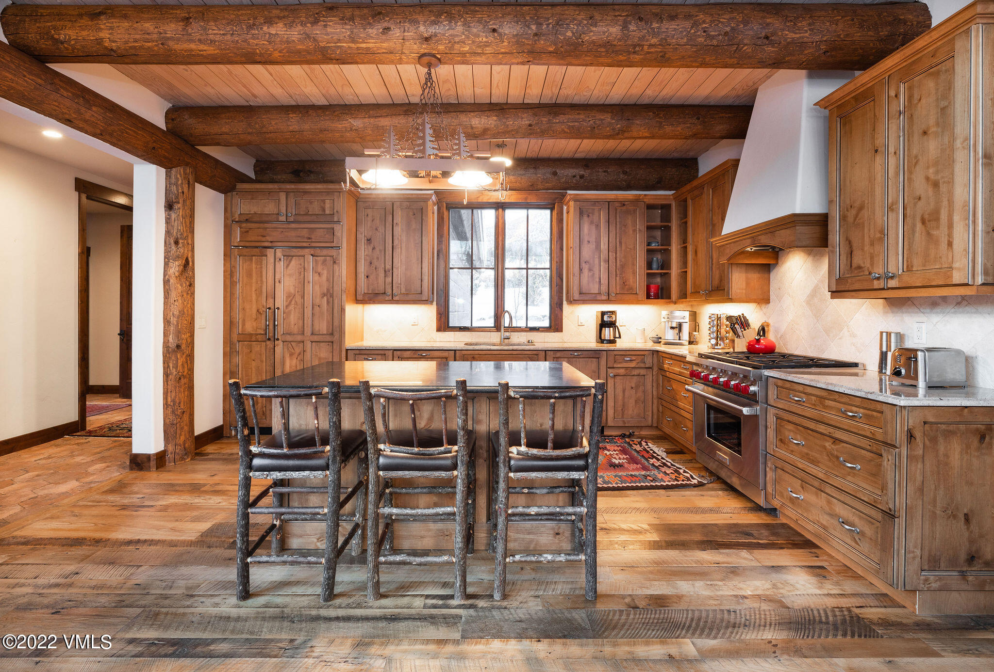 21850 Highway 6 Eagle, CO 81631 - Photo 8 of 27 a kitchen with stainless steel appliances granite countertop a stove top oven a sink dishwasher a dining table and chairs with wooden floor