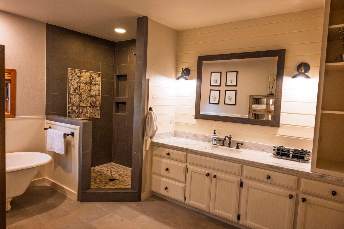 5100 Farm To Market Road 690 Burnet, TX 78611 - Photo 4 of 10 Full bathroom with walk in shower, a soaking tub, vanity, dark tile patterned flooring, and recessed lighting
