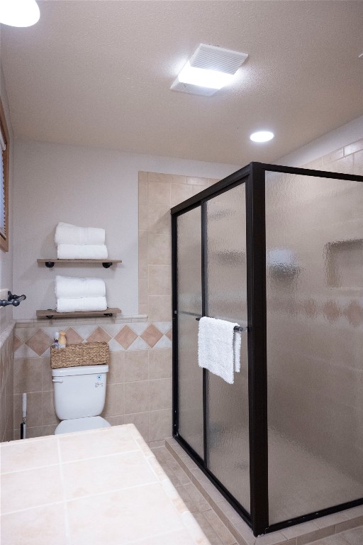 5100 Farm To Market Road 690 Burnet, TX 78611 - Photo 6 of 10 Full bathroom featuring tile walls, a stall shower, and recessed lighting