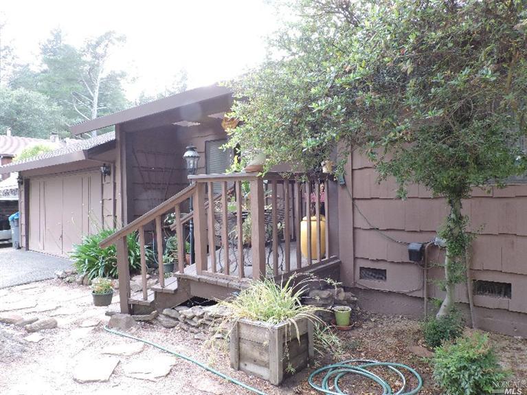 194 Brush Creek Road Santa Rosa, CA 95404 - Photo 1 of 1 a backyard of a house with table and chairs potted plants