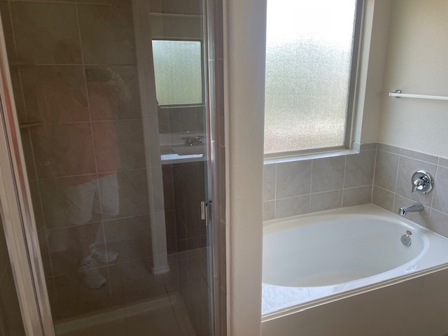 10201 Gertrudis Loop Austin, TX 78747 - Photo 16 of 24 Relax in the deep soaking tub, surrounded by tasteful tile work and naturally illuminated by a privacy window.