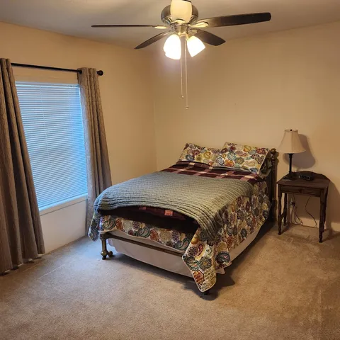 a bathroom with a sink a toilet and shower curtain