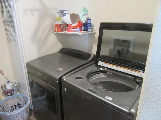 a view of a patio with couches table and chairs and potted plants