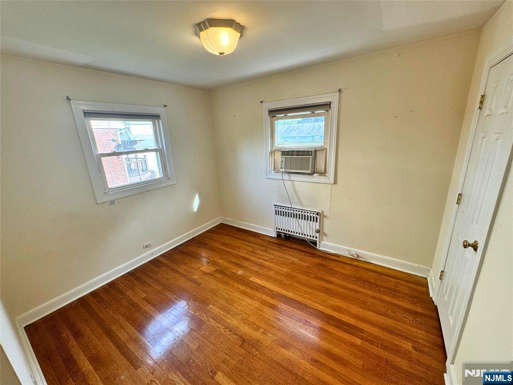11-02 Charles Street Fair Lawn, NJ 07410 - Photo 13 of 15 a view of an empty room with wooden floor and a window