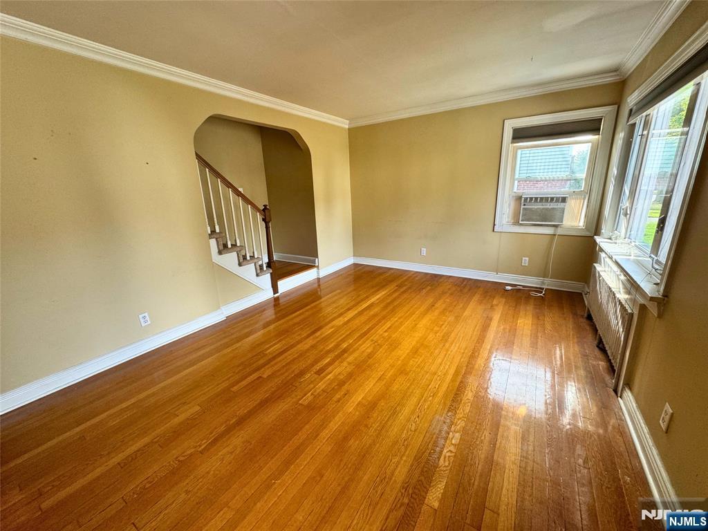 11-02 Charles Street Fair Lawn, NJ 07410 - Photo 3 of 15 a view of an empty room with wooden floor and a window