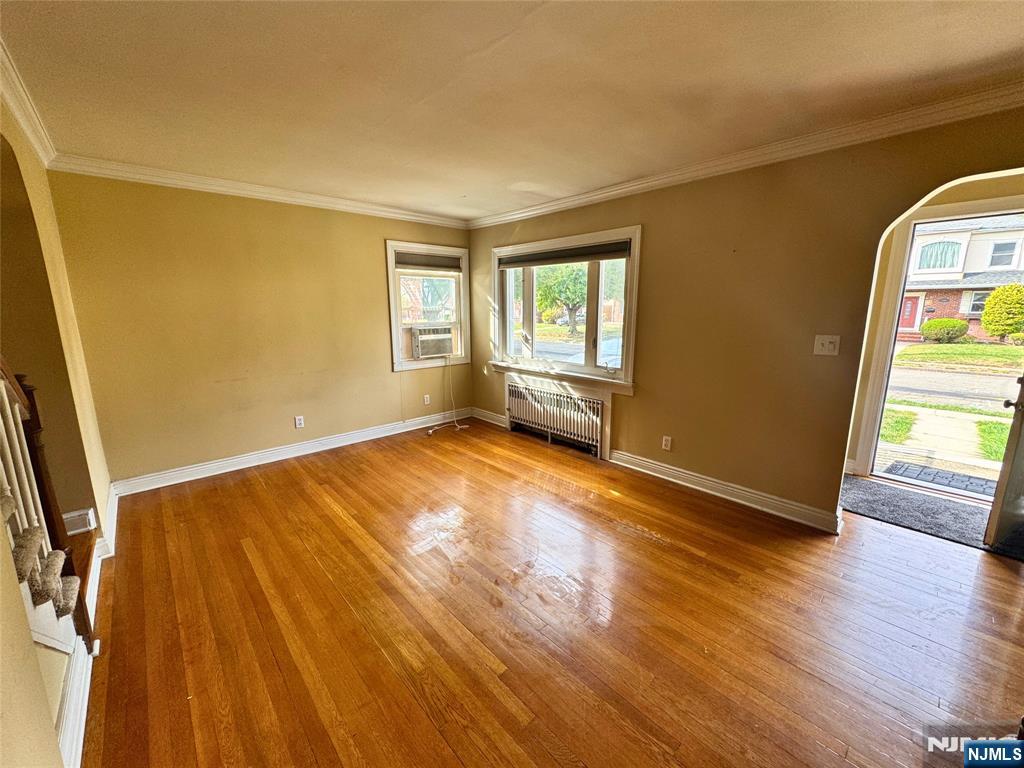 11-02 Charles Street Fair Lawn, NJ 07410 - Photo 4 of 15 a view of empty room with wooden floor and fan