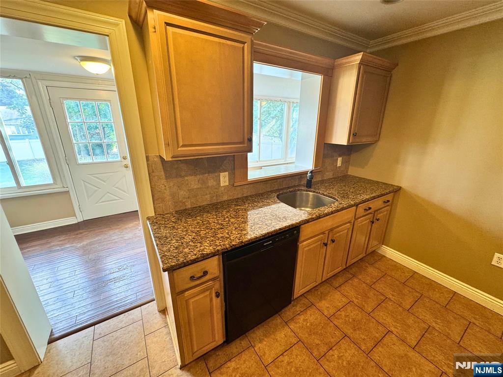 11-02 Charles Street Fair Lawn, NJ 07410 - Photo 6 of 15 a kitchen with stainless steel appliances granite countertop a sink stove and cabinets