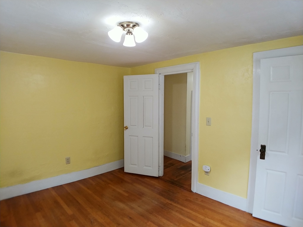 77 Hudson Street, Unit 2 Marlborough, MA 01752 - Photo 8 of 30 a view of empty room with wooden floor