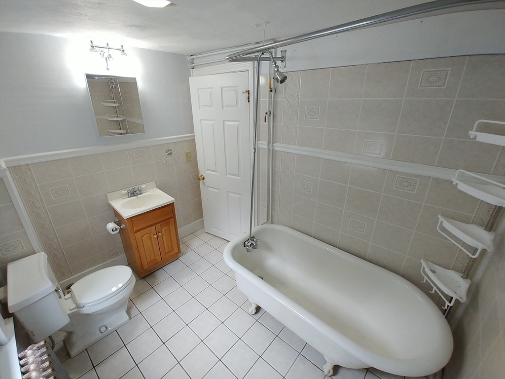 77 Hudson Street, Unit 2 Marlborough, MA 01752 - Photo 10 of 30 a bathroom with a toilet and a shower