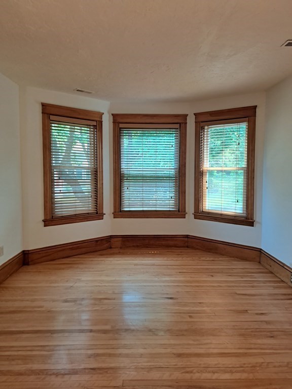 24 Clearview Avenue, Unit 2 Worcester, MA 01605 - Photo 11 of 32 a view of an empty room with wooden floor and a window