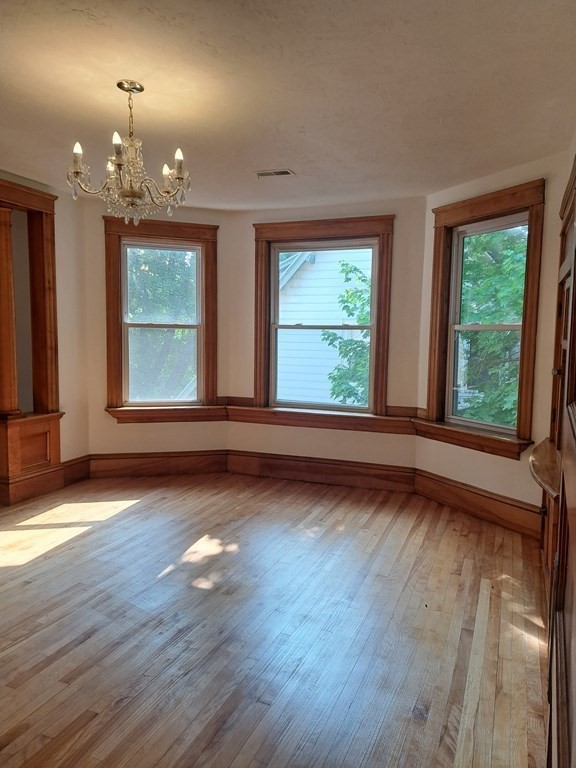 24 Clearview Avenue, Unit 2 Worcester, MA 01605 - Photo 12 of 32 an empty room with wooden floor and windows