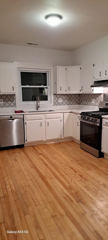 24 Clearview Avenue, Unit 2 Worcester, MA 01605 - Photo 16 of 32 a kitchen with stainless steel appliances granite countertop a stove a sink and a microwave