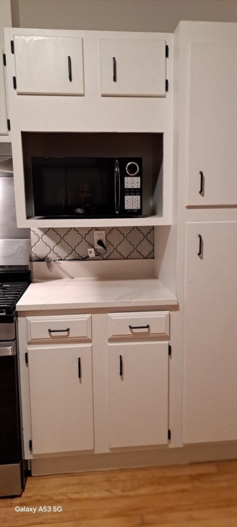 24 Clearview Avenue, Unit 2 Worcester, MA 01605 - Photo 17 of 32 a stove top oven sitting inside of a kitchen