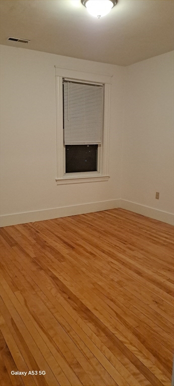 24 Clearview Avenue, Unit 2 Worcester, MA 01605 - Photo 18 of 32 a view of an empty room with wooden floor and a window