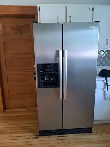 a kitchen with metallic refrigerator freezer and a dishwasher