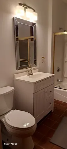 a bathroom with a toilet sink and mirror