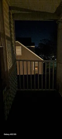 a view of a hallway with wooden floor and closet