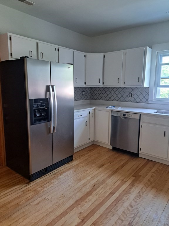 24 Clearview Avenue, Unit 2 Worcester, MA 01605 - Photo 4 of 32 a kitchen with granite countertop stainless steel appliances a refrigerator and a sink