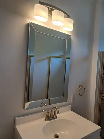a bathroom with a sink and a mirror