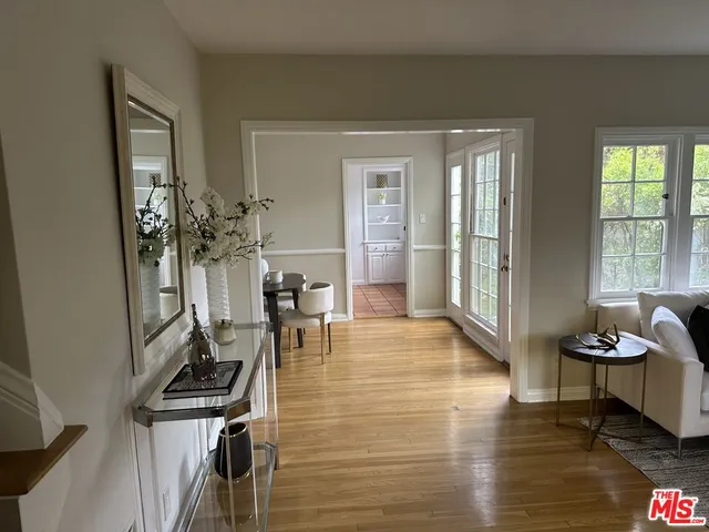 a view of a livingroom with workspace and a window