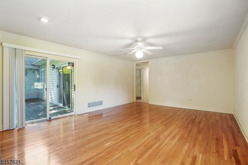 22 Court Road Morris Plains, NJ 07950 - Photo 19 of 28 an empty room with wooden floor and fan