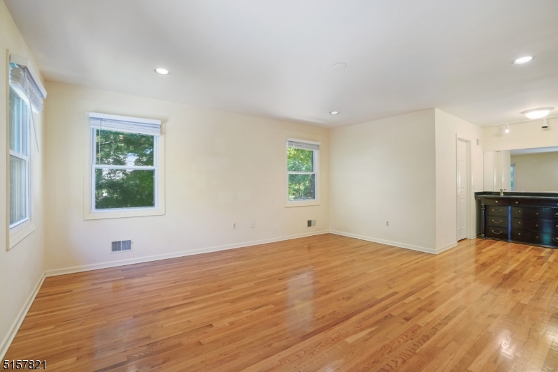 22 Court Road Morris Plains, NJ 07950 - Photo 20 of 28 a view of empty room with wooden floor and fan