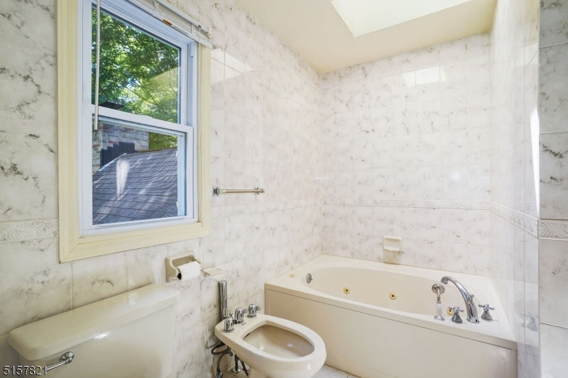 22 Court Road Morris Plains, NJ 07950 - Photo 25 of 28 a bathroom with a tub a sink and a window