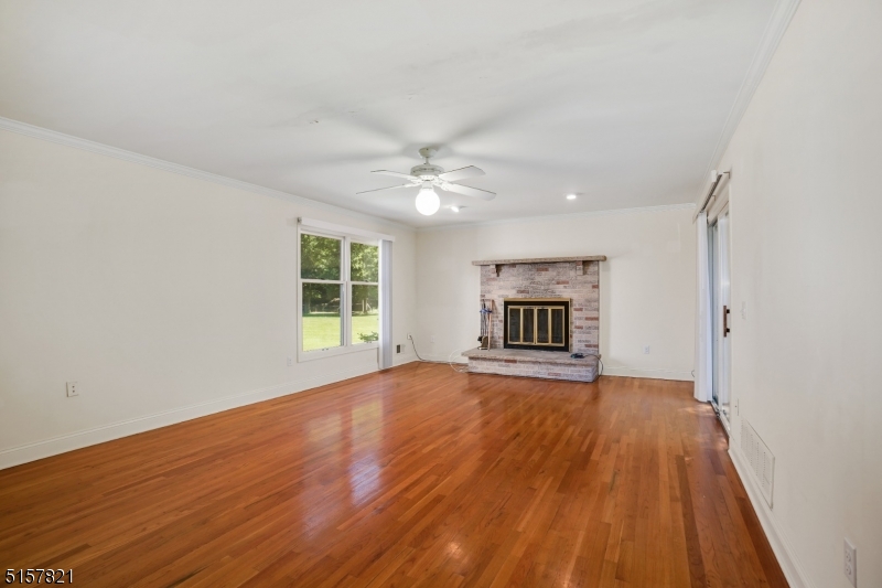 22 Court Road Morris Plains, NJ 07950 - Photo 8 of 28 a view of an empty room with wooden floor fireplace and a window